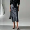Estilo europeo y americano moda elegante costura de cuero PU cintura alta adelgazante falda con abertura falda de cuero PU de longitud media