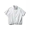 Nanxia Disguise 2026 Verão Nova Camisa Desconstruída de Cor Sólida Manga Curta Masculina Barra Elástica Camisa Solta de Meia Manga Tendência