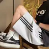 Pantalones cortos para hombre, pantalones de longitud media para el verano 2026, marca de moda, transpirables, holgados, finos, pantalones casuales de cintura media para hombre