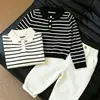 Conjunto de polo a rayas de manga larga para niño estilo coreano de otoño 2026 nuevo moderno versátil pantalones casuales para niños