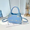 2026 Verano Nuevo Elegante Lindo Gato Dibujos Animados Femenino Simple Versátil Moderno Bolso de Hombro Cruzado Bolso de Mano