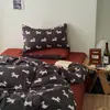 Juego de ropa de cama de cuatro piezas de algodón puro estilo Muji sábana de algodón funda de edredón rayas blancas y negras sensación de lujo ligero alta gama ropa de cama juego de tres piezas para dormitorio