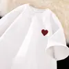 Venta al por mayor del fabricante Moda callejera americana Camisetas de manga corta estampadas de seda helada de manga tres cuartos, holgadas y versátiles, camisetas de verano