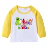 Camiseta infantil de primavera y otoño 2023, nueva camiseta de manga larga con cuello redondo y dibujos animados, camiseta de algodón para bebés y niños.