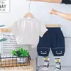 Comercio Exterior Ropa Infantil al por Mayor 2025 Nuevo Verano Lindo Cuadrado Cara Sonriente Traje de Manga Corta Camiseta Pantalones Cortos Traje