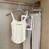 Top tipo camiseta interior de una pieza con cuello halter, estilo Spice Girls, espalda en forma de I y almohadilla para el pecho, largo y combinable para mujer.