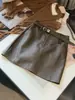 Falda de cuero PU de estilo coreano a la moda, ajustada a la cadera para mujer, nuevo diseño de línea A otoño/invierno, adelgazante, de cintura alta, elegante y previene la exposición