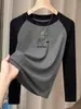 Camiseta de manga larga de algodón puro con bloques de color para mujer, moderna y versátil, adecuada como capa base, con mangas raglán, otoño 2026