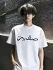Top de verano para hombre de estilo simple, exclusivo transfronterizo, bordado, de manga corta, con mangas acanaladas tridimensionales en los hombros y cuello pequeño