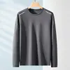 Camiseta de manga larga para hombre, adecuada para primavera y otoño, corte holgado, cuello redondo, capa interior fina, base elástica, versátil y moderna
