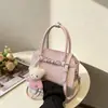 2026 Nova Bolsa Quadrada Pequena Estilo Minimalista Bolsa de Mão Versátil Exquisita Bolsa de Ombro Fashionável Bolsa Transversal de Design de Nicho Tendência