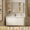 Tocador de baño engrosado y ahorrador de espacio con diseño en color crema, que cuenta con un lavabo redondeado, lavabo cerámico integrado y un lavabo de una sola pieza.