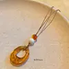 Nuevo Collar con Colgante de Estilo Étnico Chino para Mujer 2025 Nuevo Diseño de Nicho Cadena Larga para Suéter de Gama Alta