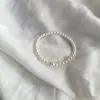 Pulsera de Perlas Familia Shi Exquisita Nicho Cubo de Azúcar Zirconita Pulsera Elástica Tacto de Alta Gama Nuevo Estilo 2026 Pulsera para Mejor Amiga