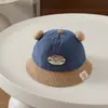 Chapéu de pescador infantil estilo coreano, chapéu de pescador com bloqueio de cores de urso sorridente com duas bolas, outono e inverno, chapéu de bebê unissex