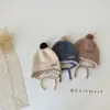 Gorro de Bebé Lindo con Bola de Pelo Estilo Coreano Otoño e Invierno Estilo Nuevo Protección para Orejas Cálido Cortavientos con Cordones Gorro de Lana para Niños y Niñas