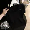 Camiseta Feminina Gola Polo Tricô Canelado Seda Gelada Manga Curta Verão 2026 Solta Emagrecedora Versátil Redutora de Idade