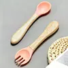 Juego de vajilla de silicona de grado alimenticio más vendido transfronterizo, taza de leche, ventosa, plato con cara sonriente, babero de silicona, tenedor y cuchara con mango de madera