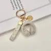 Llavero de Audífonos con Pedrería de Cristal Llavero Musical Completamente Cubierto de Pedrería Adorno Colgante de Cuerda de Diamante para Bolso Accesorios Llavero de Coche