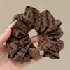 Temperamento Outono Inverno 2026 Novo Prendedor de Cabelo Estilo de Cabelo Atmosfera Francesa Prendedor de Cabelo Xadrez Alta Elasticidade Anel de Cabelo de Intestino Grosso Acessórios de Cabelo