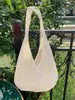 Bolso tejido de nicho de moda estilo coreano, bolso de mano tejido simple calado para mujer, bolso de hombro casual estilo vacacional