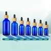Botellas de aceite esencial azules al por mayor, disponibles en varios tamaños, con tapas gotero resistentes a la luz, botellas vacías para sueros y botellas dispensadoras cosméticas portátiles