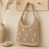 Bolso de mano tejido hueco, nuevo bolso de hombro simple, versátil y elegante, bolso de playa estilo vacacional, bolso de mano de moda para mujer