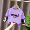 Camiseta base para niño 2026 nuevo modelo camiseta de manga larga a rayas patchwork para niños top de algodón puro otoño para niños mayores
