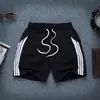 Verano 2023 nuevos pantalones cortos para hombre, pantalones de correr de tres cuartos, holgados, talla grande, simples para estudiantes, secado rápido, pantalones de playa, pareja