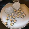 Brincos Europeus e Americanos de Agulha de Prata com Coração Cravejado de Diamantes e Borla 2026 Novo Estilo Estética Fria Personalidade Tarraxas de Orelha Nicho Toque de Luxo Ornamentos de Orelha