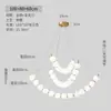 Lámpara colgante minimalista francesa con forma de frijol curvado, decoración de bola blanca lechosa de moda, lámpara colgante lineal larga para mesa de isla de comedor