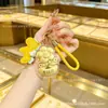 Oro puro 999 "Youqianhua" cadena para teléfono móvil de oro llavero colgante para bolso caja de regalo regalo pequeño promocional personalización cultural y creativa