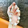 Cadena para teléfono con lazo y cuentas cuadradas transfronteriza, llavero, accesorio colgante de moda para bolso de niña, regalo pequeño, venta al por mayor