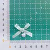 26 Nuevos Accesorios Importados de Moño de Cinta Colgante de Corazón Accesorios para Ropa de Muñecas DIY Suministros de Decoración