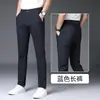 Calças casuais de seda gelada de Hong Kong para homens, calças finas justas para primavera e verão, calças sociais ultra-elásticas da moda estilo coreano