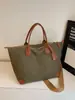 Bolsa de Lona Super Popular Transfronteiriça com Cores Contrastantes para Mulheres 2025 Nova Obra Commuter Portátil Bolsa Tote Retrô Versátil Bolsa Feminina
