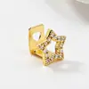 Grillz de Hip Hop Chapados en Oro de 18 Quilates Transfronterizos Europeos y Americanos Unisex Personalidad Cinco Estrellas Incrustados con Diamantes Adorno Dental para Diente Único/Doble
