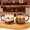 Venta al por mayor de fábrica taza de café de vidrio con asa estilo nórdico taza de leche taza de barriga grande taza transparente para avena desayuno