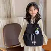 Mochila Nueva Estilo para Niñas de Jardín de Infancia, Mochila Elegante de Color Sólido con Tapa Plegable y Cierre de Cordón, Mochila Pequeña Informal para Salidas, Transfronterizo