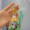 Enfeites de mesa preenchidos com óleo gato da sorte de areia movediça dourada chaveiro de acrílico criativo pingente de bolsa pequenos presentes atacado