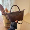 Bolso cruzado tejido de diseño de nicho nuevo 2026, bolso de mano versátil casual para mujer, estilo albóndiga