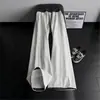 Pantalones de chándal de cuadros patchwork deconstruidos negros para hombre, marca de tendencia de otoño, pantalones rectos de alta gama que estilizan, pantalones de microcampana estilo americano