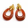 Aretes de acero de titanio transfronterizos Yuhui, con un diseño geométrico hueco de resina de color ámbar estilo Melard, aretes de acero inoxidable