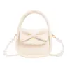 Bolso de mano para niña con lazo dulce, elegante bolso cruzado con cadena de perlas mini, bolso accesorio de color sólido para niños