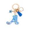 Llavero Colgante Temático Océano Azul con Borla de Estrella de Mar, Llavero de Resina Encanto para Bolso con 26 Letras