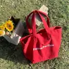 Nova Bolsa de Lona Vermelha Ins de Nicho Bolsa de Ombro de Lona Casual com Estampa de Letras Grande Capacidade Bolsa de Estudante