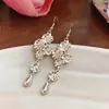 Pendientes colgantes con borlas florales transfronterizos europeos y americanos, lujo ligero, alta gama, ganchos para la oreja únicos, pendientes exagerados vintage para mujer