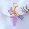 Llavero de Resina con Lentejuelas Moradas con Letra Inglesa Colgante para Bolso de Niña Borla de Mariposa Accesorios Explosiones Transfronterizas