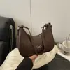 Design Laço Francês 2025 Padrão Tecido Nova Moda Elegante Personalidade Fashionável Bolsa de Ombro Único Bolsa de Axila para Mulheres