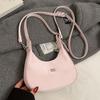 Venta al por mayor, nuevo bolso de estilo coreano de nicho, sencillo, de media luna, a la moda, combinable, de color liso, para mujer.